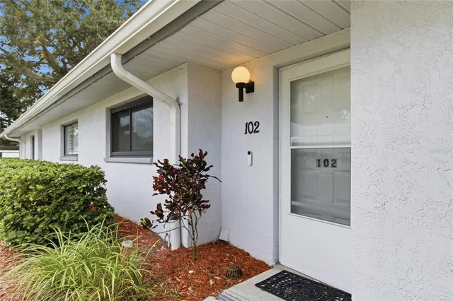 front view of a house with a potted plant