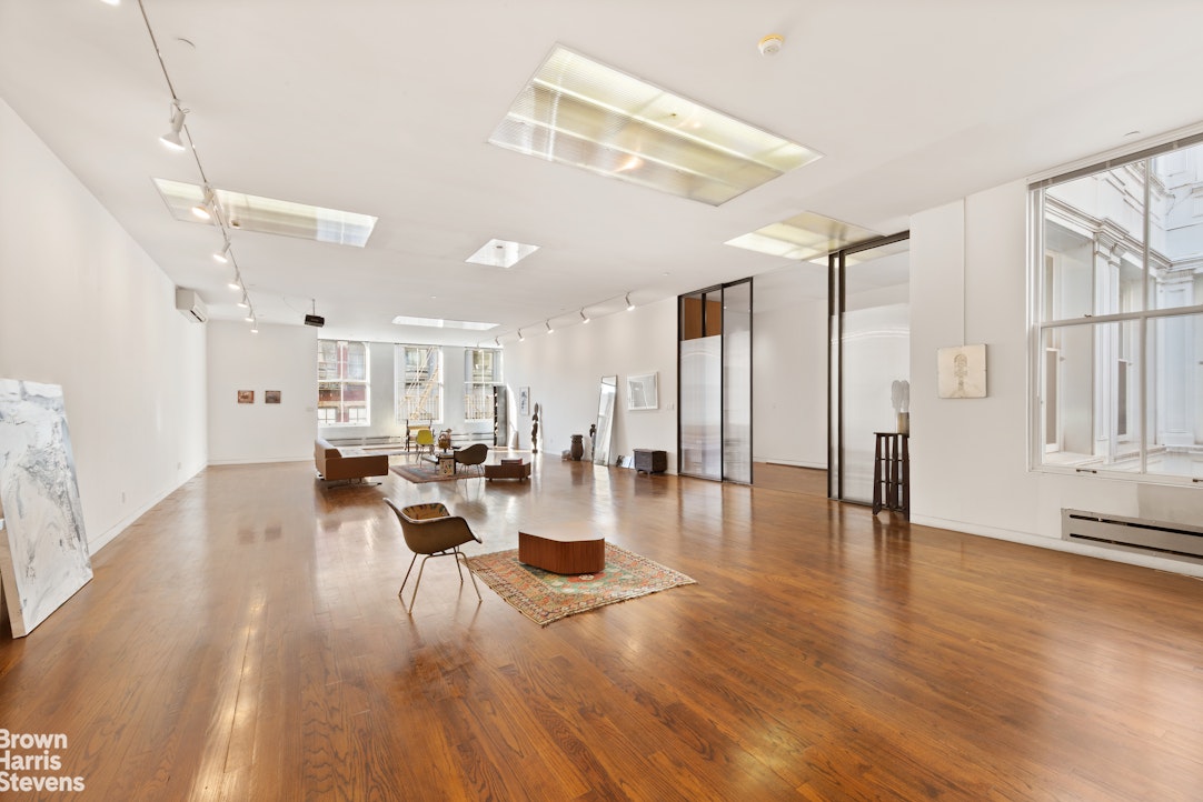 110 Mercer Street, Unit 4 Manhattan, NY 10012 - Photo 1 of 8 a living room with lots of furniture and wooden floor