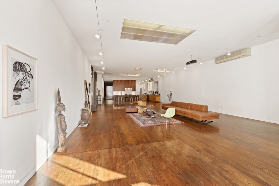 110 Mercer Street, Unit 4 Manhattan, NY 10012 - Photo 2 of 8 a living room with furniture and a wooden floor