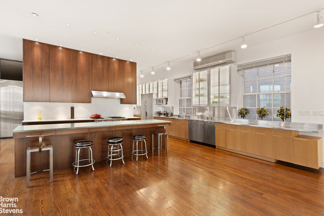 110 Mercer Street, Unit 4 Manhattan, NY 10012 - Photo 4 of 8 a large kitchen with a table and chairs