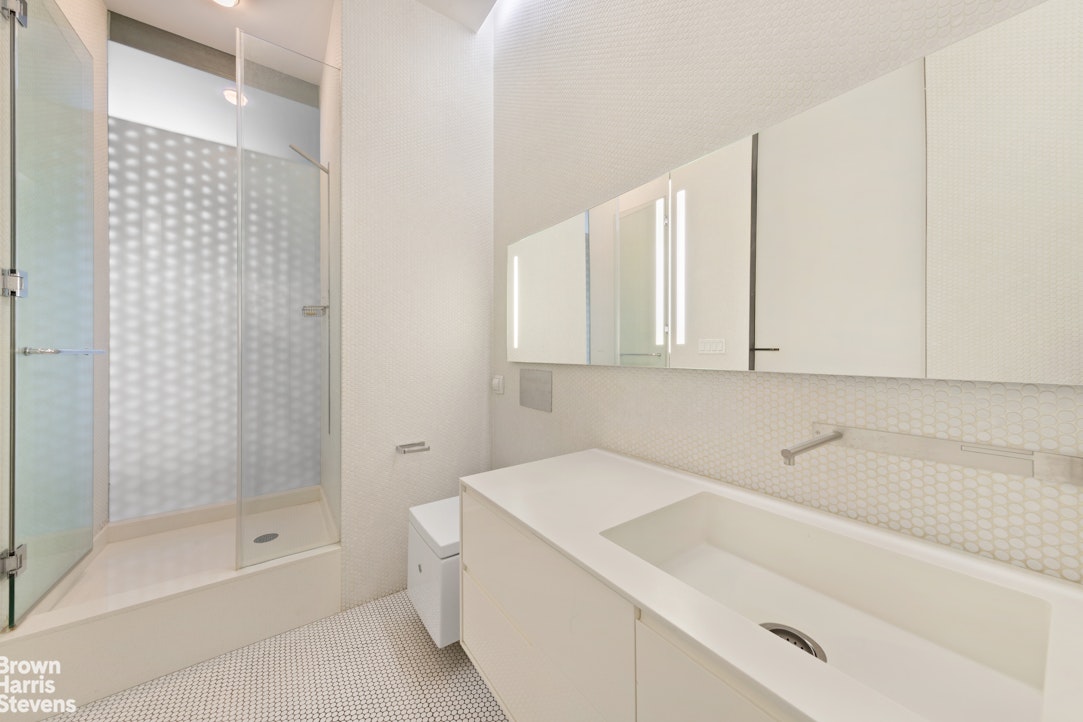 110 Mercer Street, Unit 4 Manhattan, NY 10012 - Photo 5 of 8 a bathroom with a bathtub and a shower