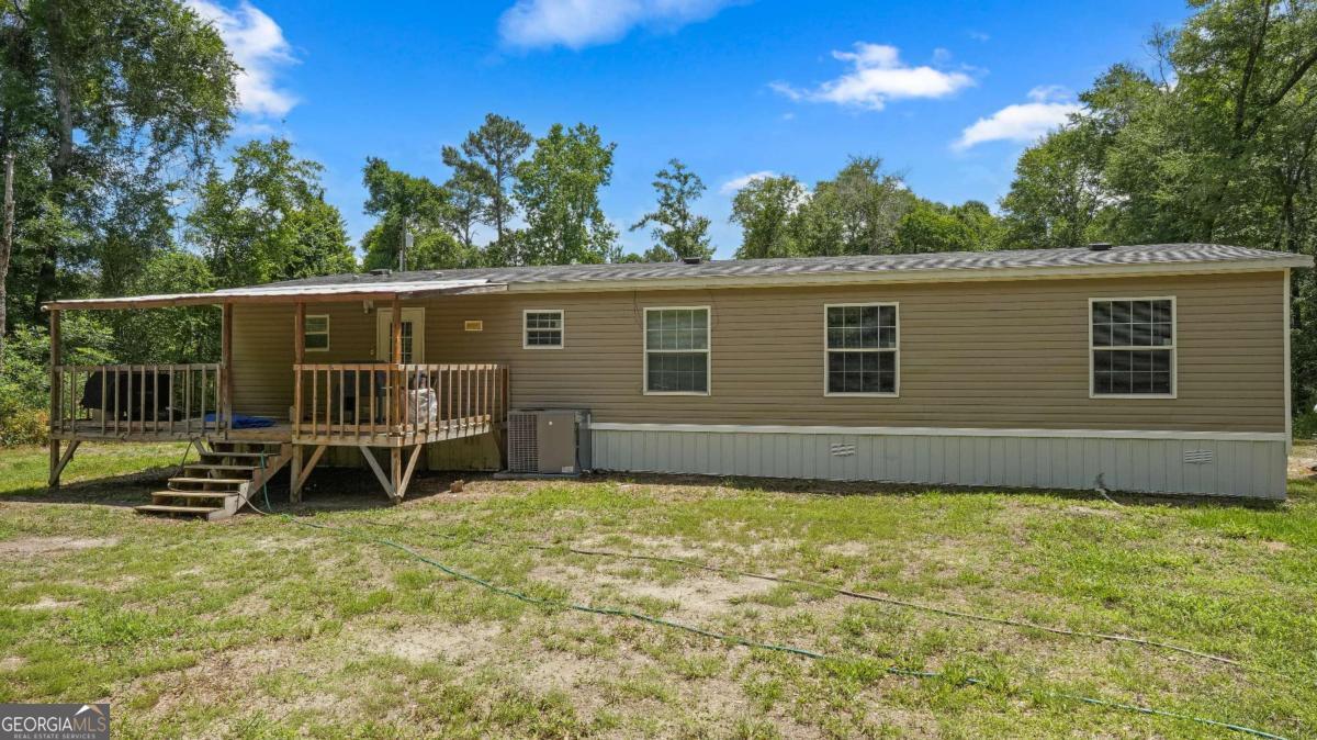 64 Sierra Road Jesup, GA 31545 - Photo 5 of 22 a view of a house with backyard and porch