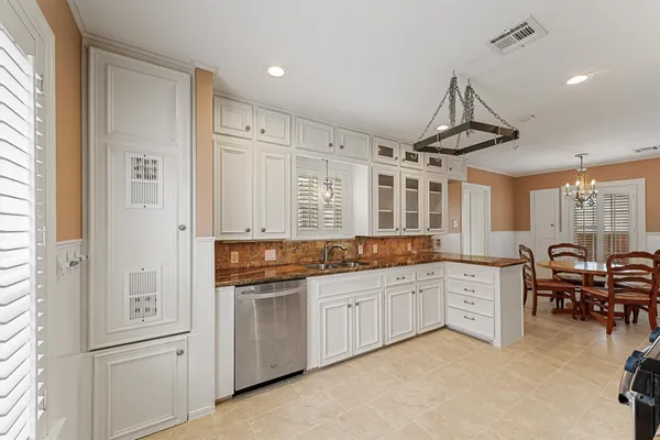 a large white kitchen with a large window