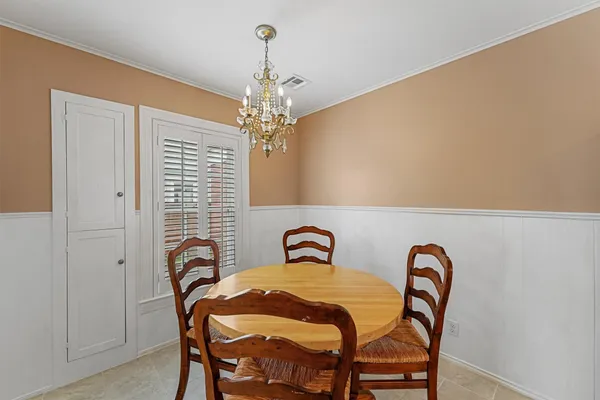 a view of a dining room with furniture and chandelier