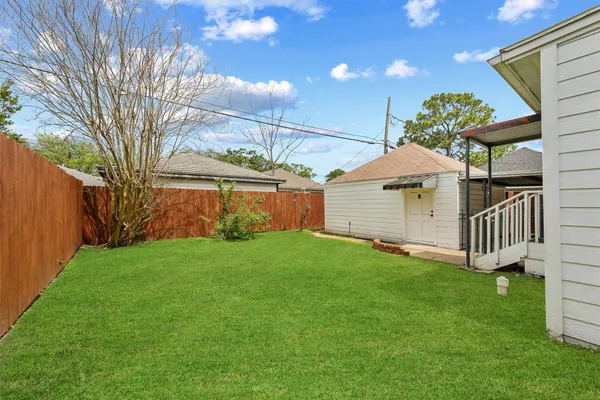 a view of a house with a yard and deck