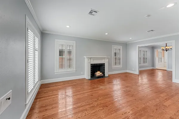 a view of an empty room with window and fire place