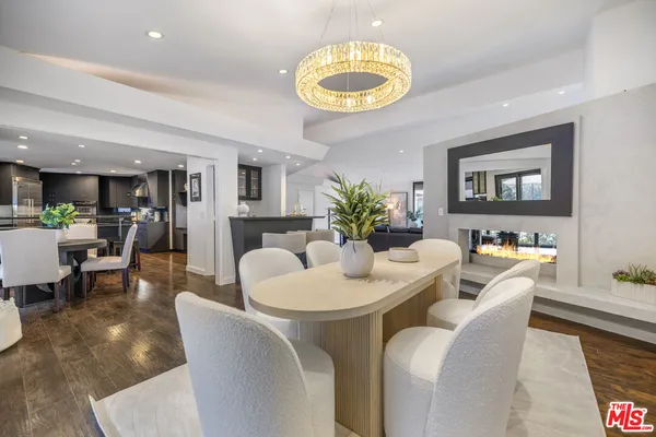 a dining room with furniture a chandelier and a rug