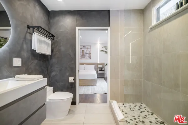 a bathroom with a toilet a sink and shower