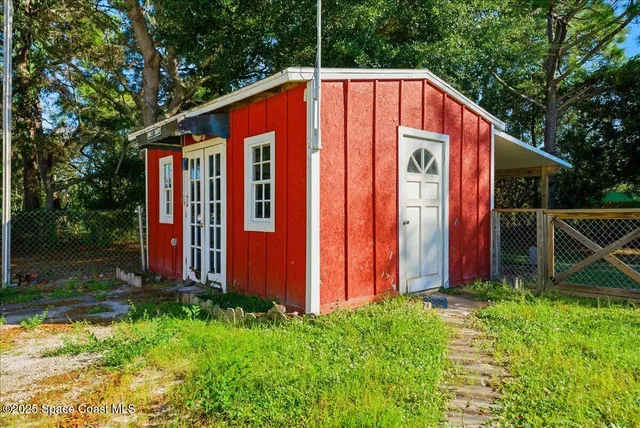 a blue and red umbrella sitting in front of a house