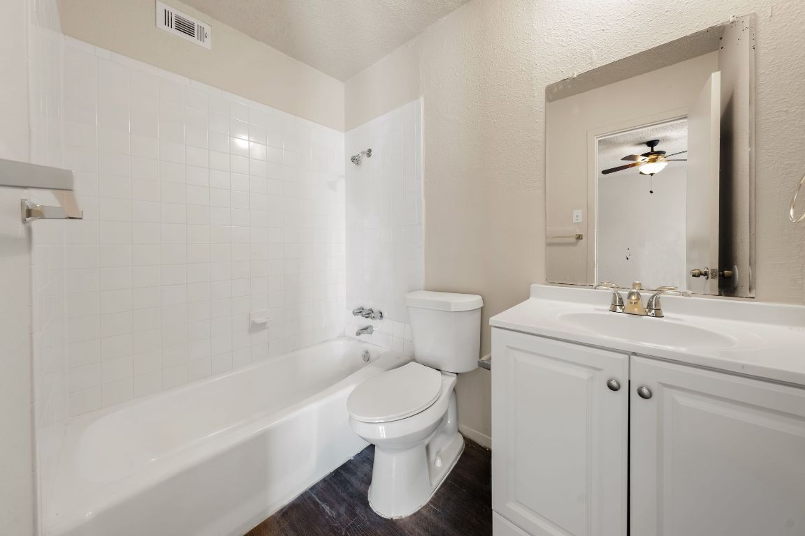 2314 Parker Lane, Unit 5 Austin, TX 78741 - Photo 11 of 17 a bathroom with a sink a toilet and shower