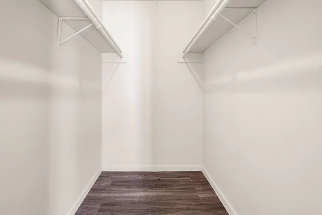 a view of a room with wooden floor