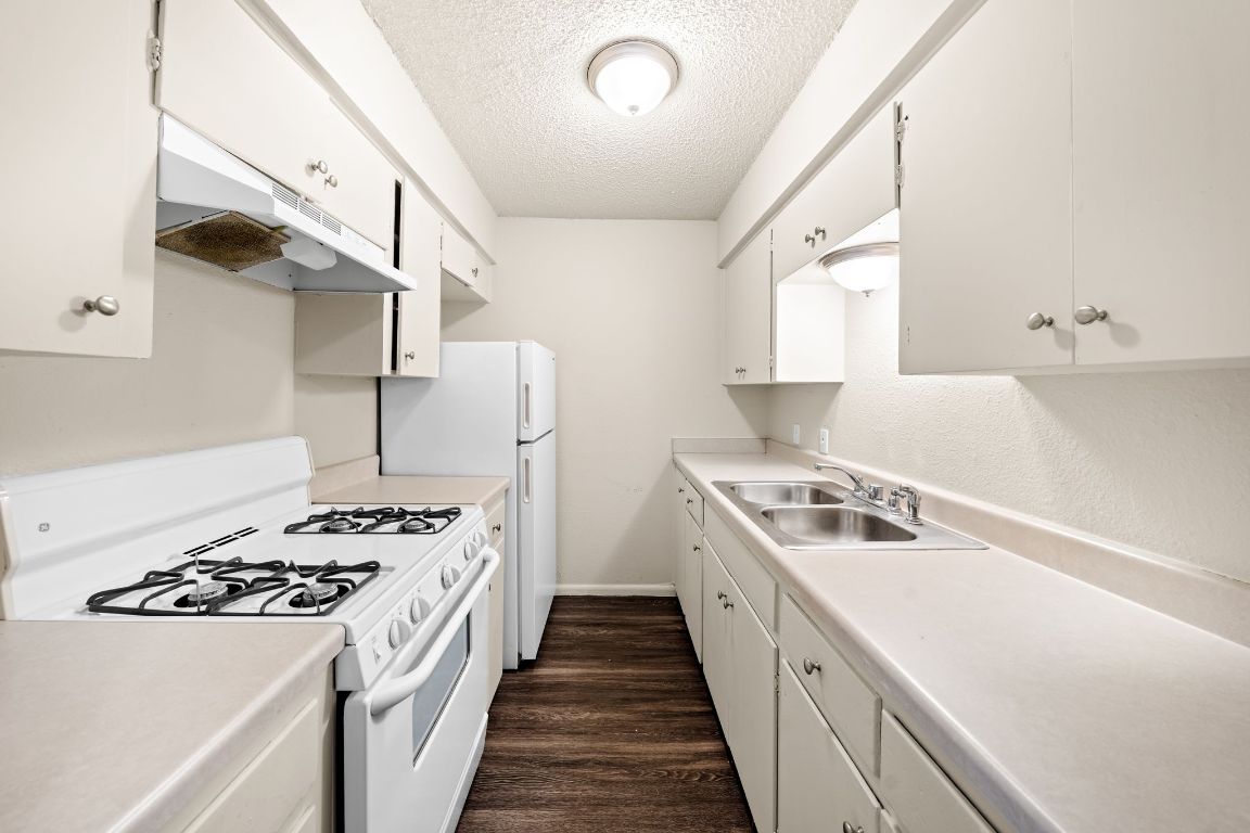 2314 Parker Lane, Unit 5 Austin, TX 78741 - Photo 5 of 17 a kitchen with a stove and a refrigerator