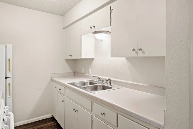 a kitchen with a sink and cabinets
