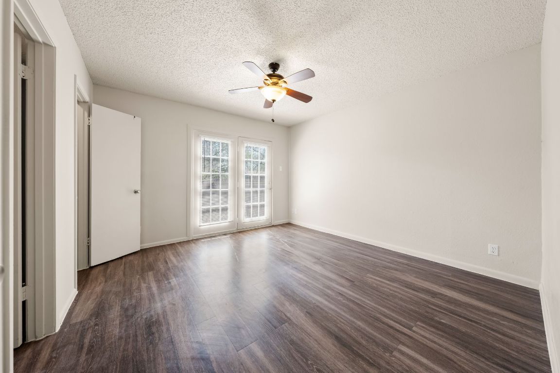 2314 Parker Lane, Unit 5 Austin, TX 78741 - Photo 9 of 17 wooden floor in an empty room with a window