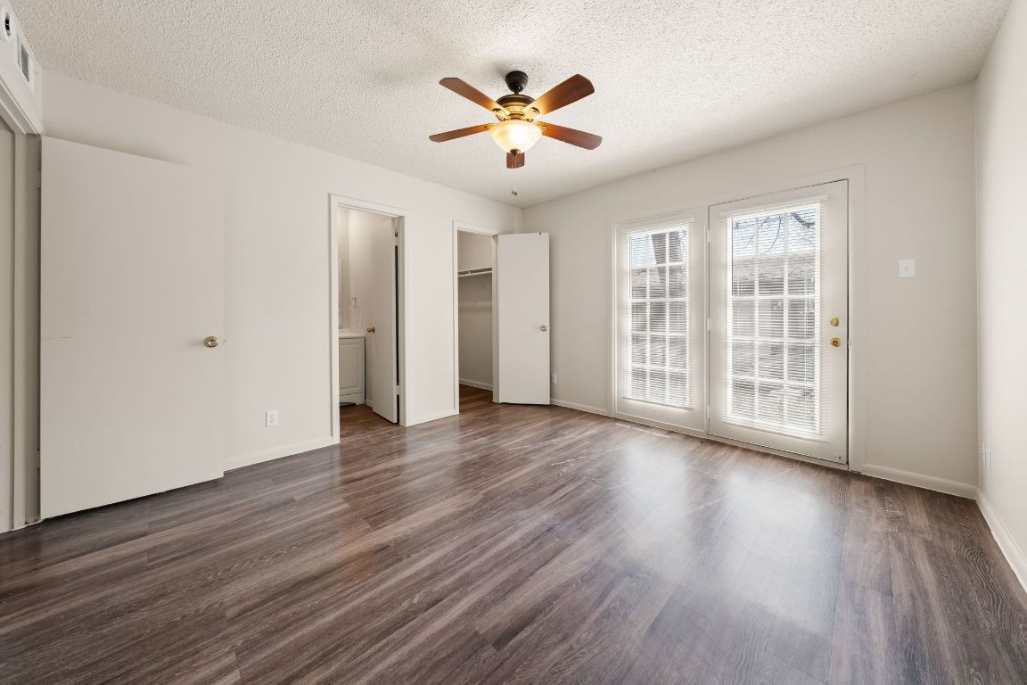 2314 Parker Lane, Unit 5 Austin, TX 78741 - Photo 10 of 17 a view of an empty room with wooden floor and a window