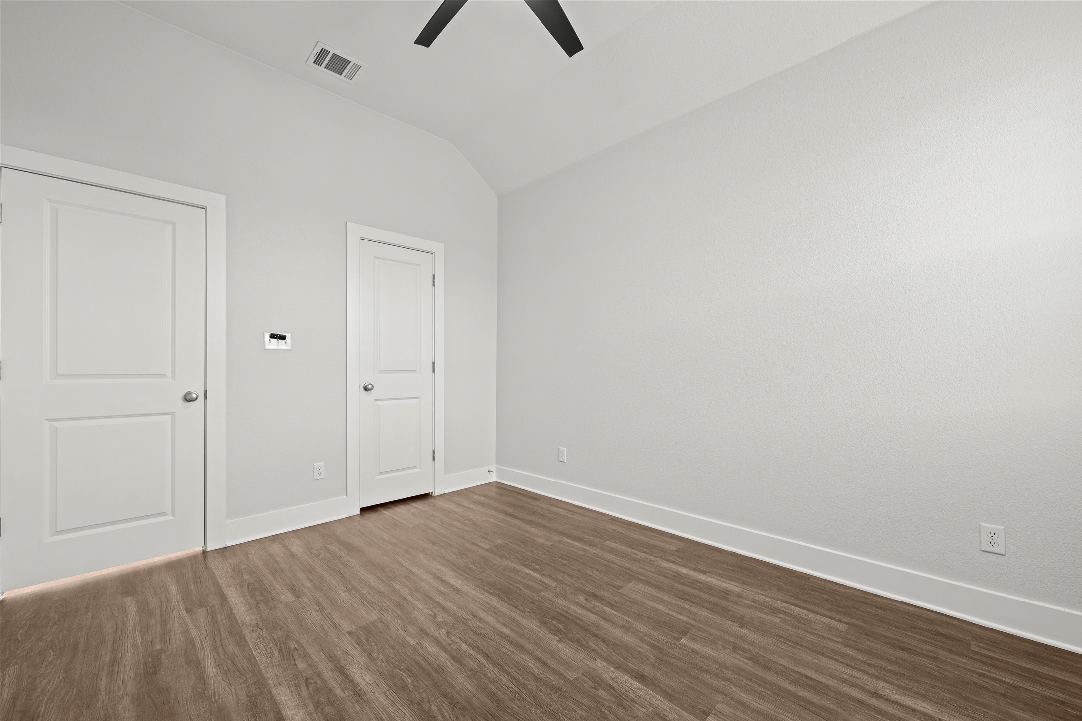 60 Rancho Trail Georgetown, TX 78628 - Photo 26 of 36 Gleaming wood-look floors complement clean white walls beneath an angled vaulted ceiling.