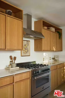 a kitchen with stainless steel appliances a sink stove and cabinets