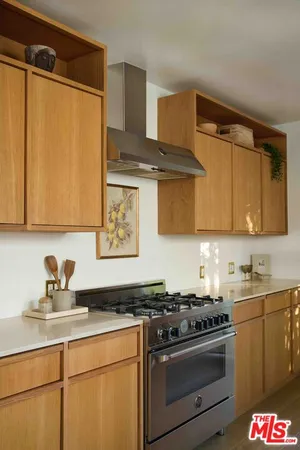a kitchen with stainless steel appliances a sink stove and cabinets