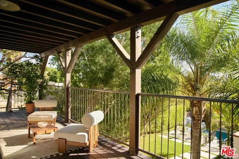 a view of a chair and tables in the balcony