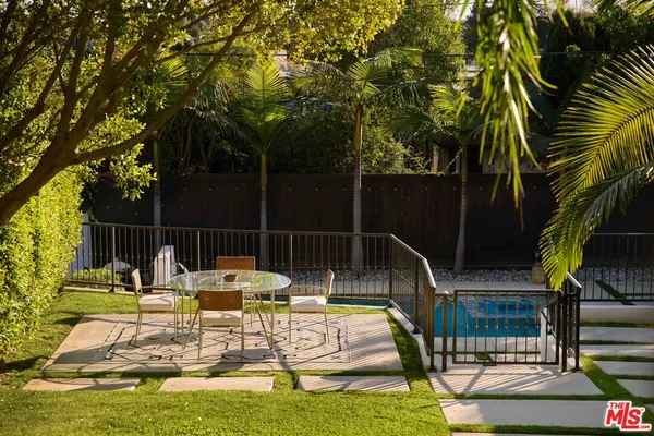 a living room with furniture a window and a potted plant