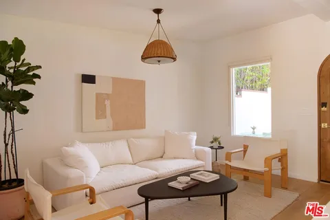 a living room with furniture and flowers