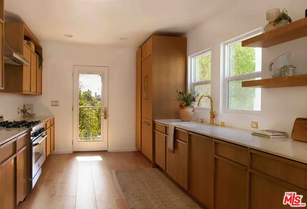 a kitchen with a sink stove and cabinets