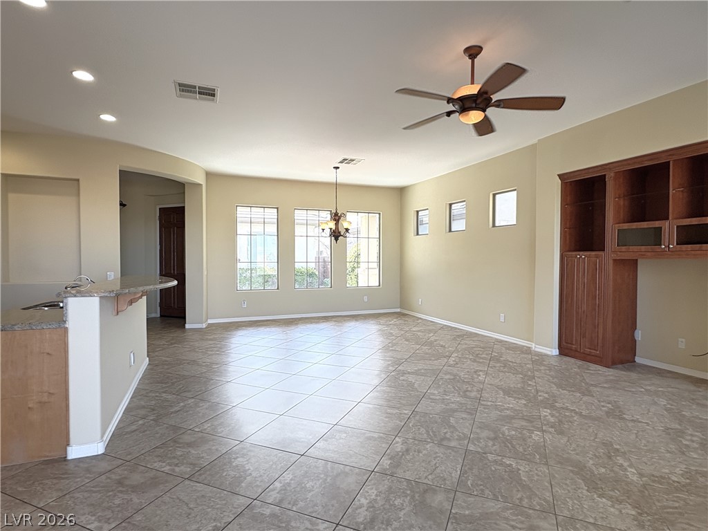 10 Caprington Road Henderson, NV 89052 - Photo 15 of 44 A spacious common area with tile flooring and multiple windows for abundant natural light.