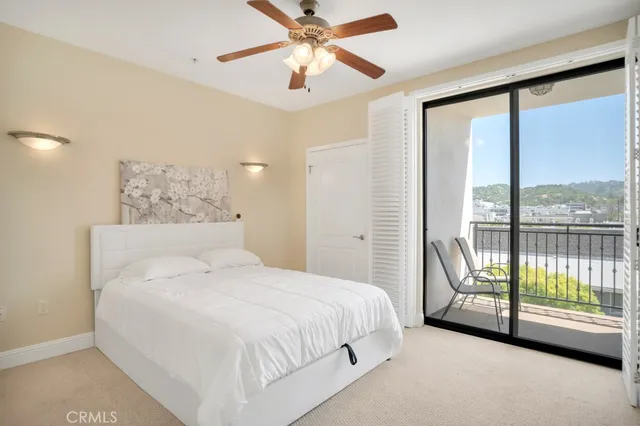 a bedroom with a bed and cabinets
