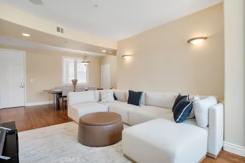 a view of an empty room with wooden floor fireplace and a window