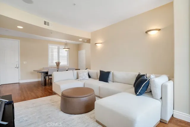 a view of an empty room with wooden floor fireplace and a window