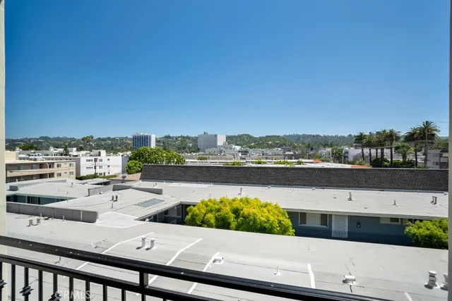 a view of a balcony with chairs
