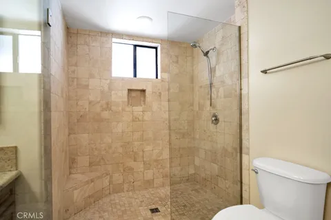 a bathroom with a granite countertop double vanity sink and a mirror