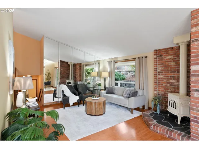 a living room with furniture floor to ceiling window and potted plants