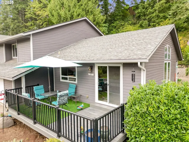 a front view of house with deck and yard