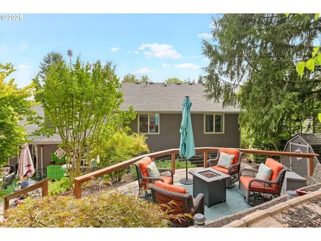 a view of a chairs and table in the back yard of the house