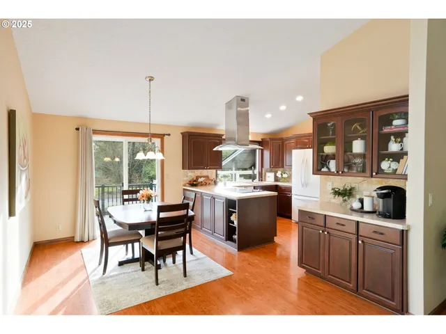 a open kitchen with a sink dining table and chairs