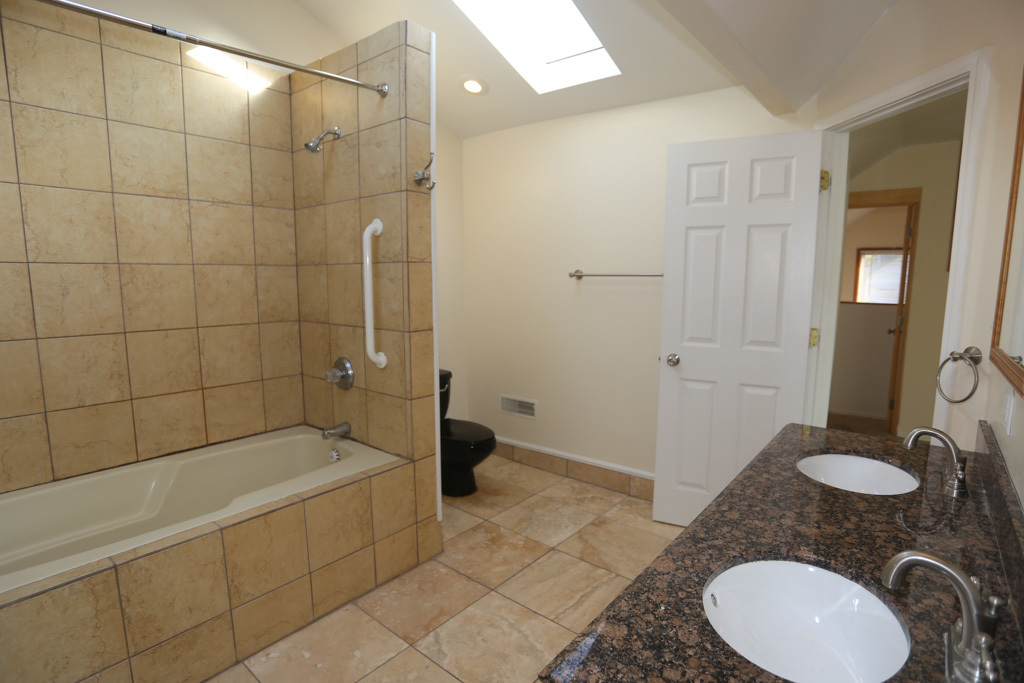 2458 North Clybourn Avenue, Unit 2F Chicago, IL 60614 - Photo 19 of 20 a bathroom with a granite countertop sink a toilet and shower