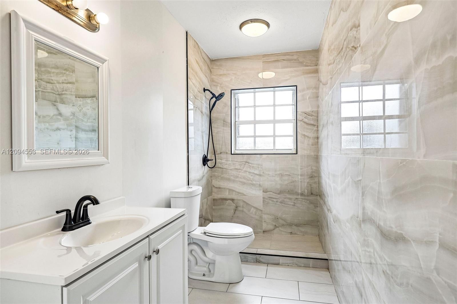 571 Northeast 172nd Street North Miami Beach, FL 33162 - Photo 6 of 33 Renovated bathroom with walk-in shower