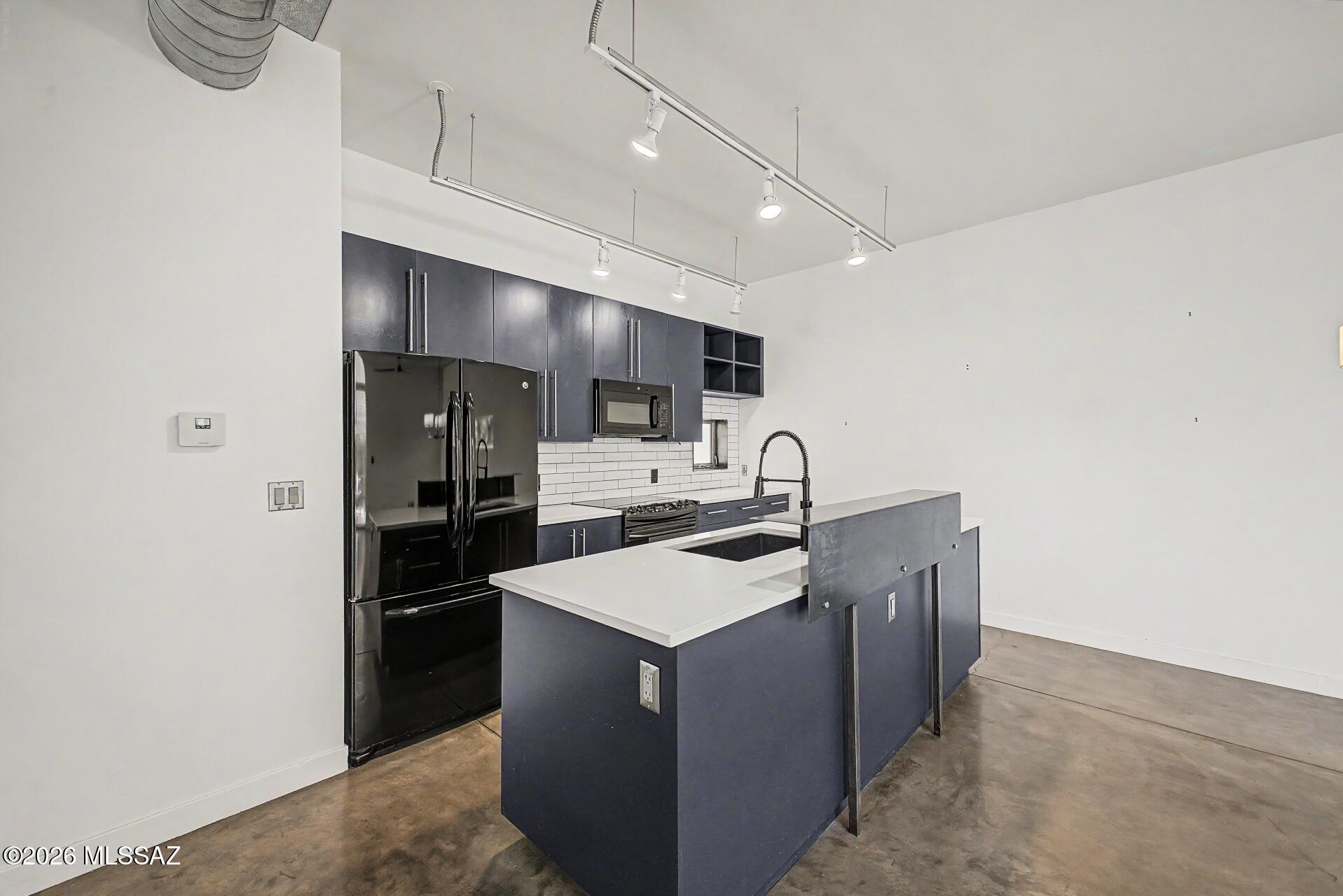 3605 East 3rd Street Tucson, AZ 85716 - Photo 4 of 39 Beautiful updated kitchen with Indigo cabinets and quartz counter tops.