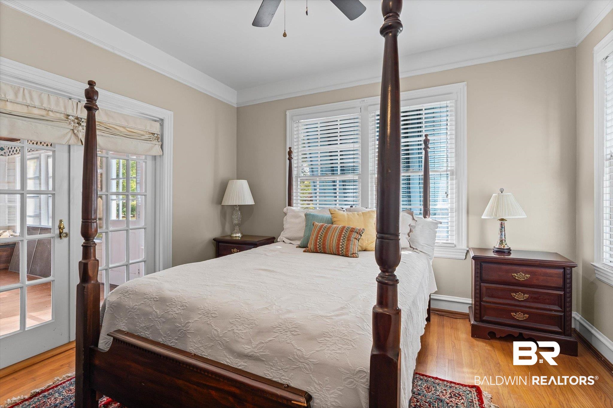 7015 Bay Road Mobile, AL 36605 - Photo 35 of 53 Guest Cottage Bedroom featuring multiple windows, light wood finished floors, ceiling fan, and ornamental molding