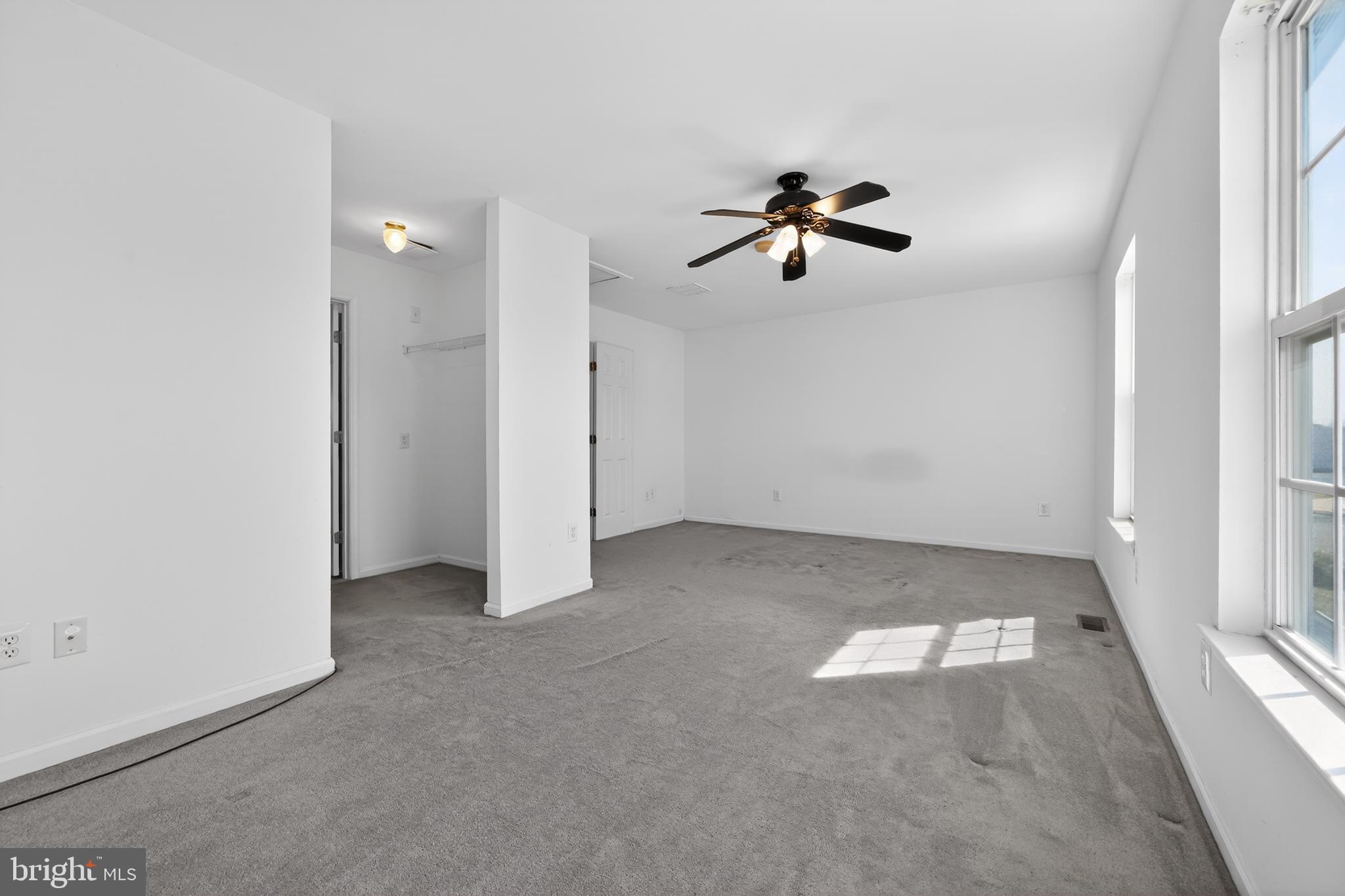 20 Colts Gait Road Marlton, NJ 08053 - Photo 25 of 36 an empty room with chandelier fan and windows