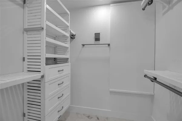 a en suite bathroom with a granite countertop sink and a mirror