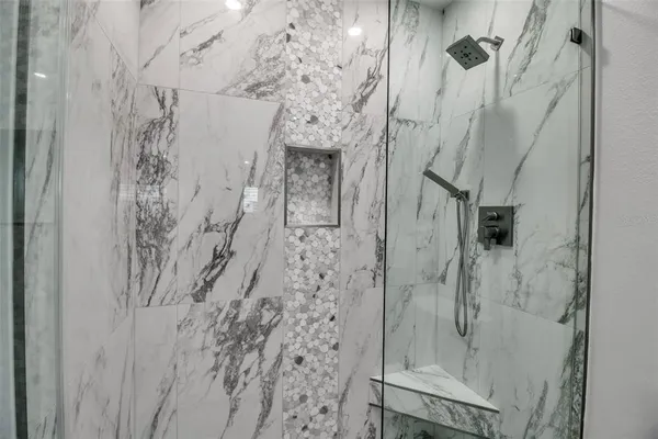 an empty room with windows and cabinet