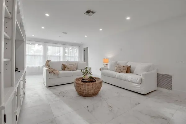 a living room with furniture and white walls