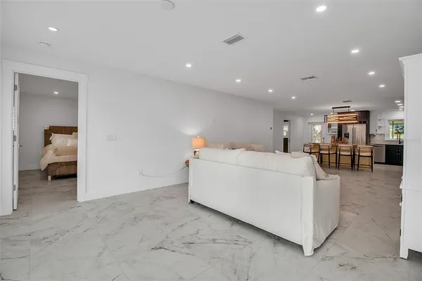 an empty room with a mirror and furniture
