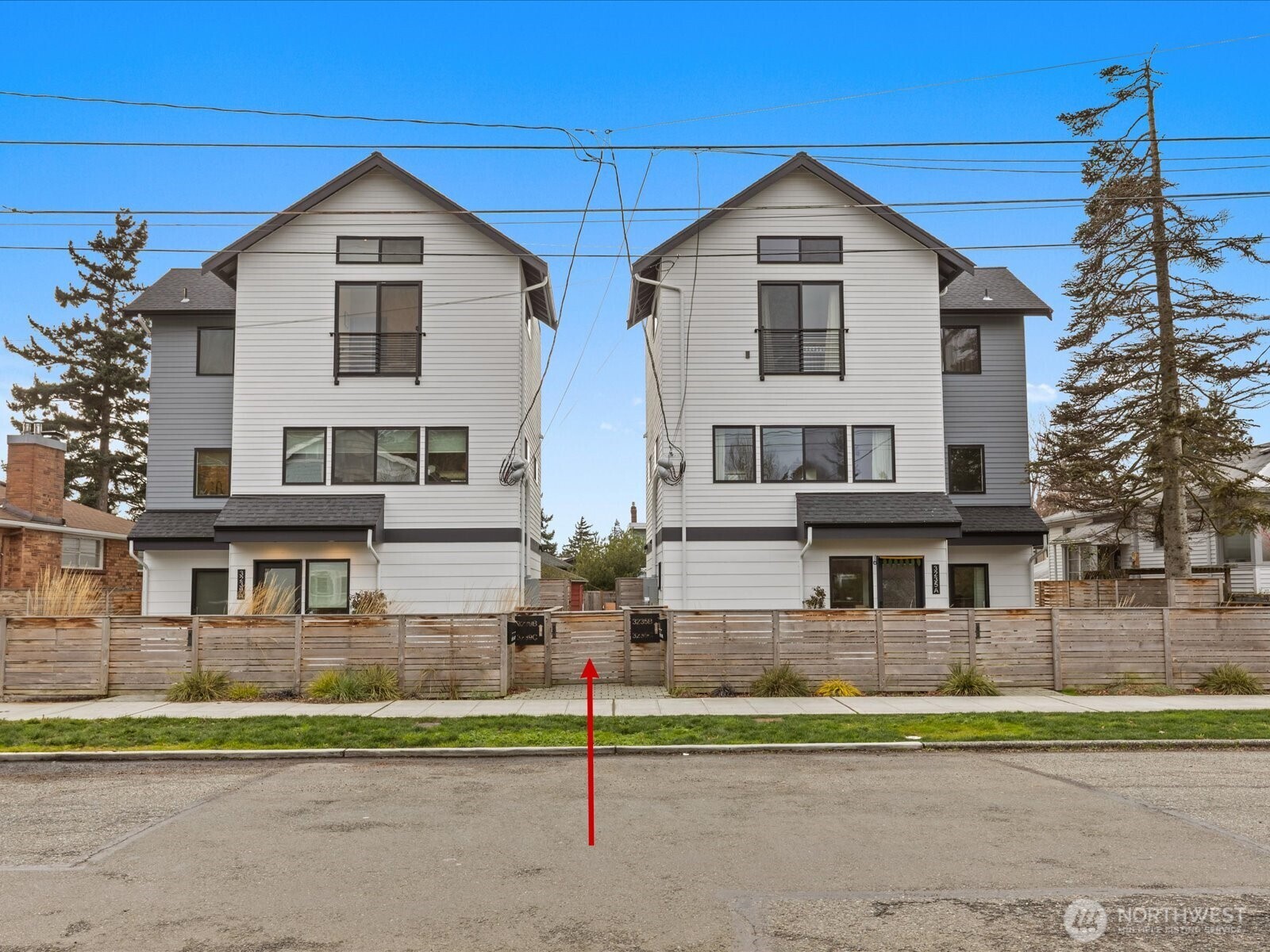 3239 61st Avenue Southwest, Unit B Seattle, WA 98116 - Photo 24 of 30 a front view of a house with a yard