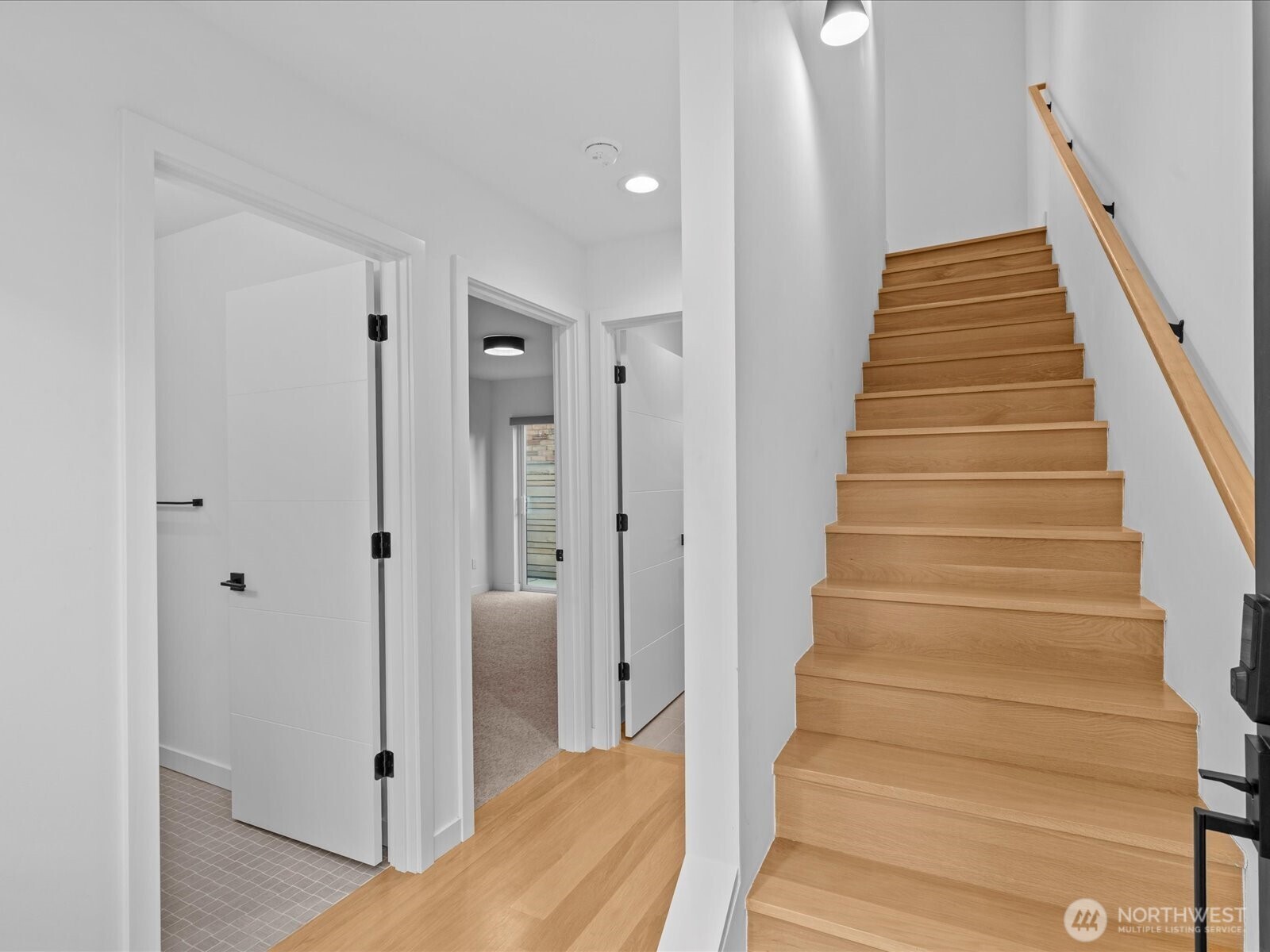 3239 61st Avenue Southwest, Unit B Seattle, WA 98116 - Photo 3 of 30 a view of staircase with wooden floor and white walls
