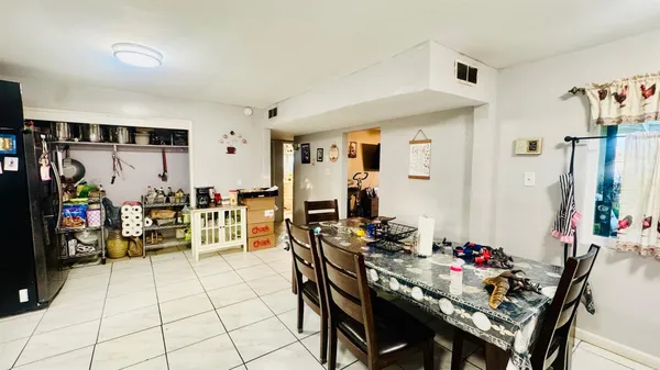 a view of a dining room with furniture and a kitchen