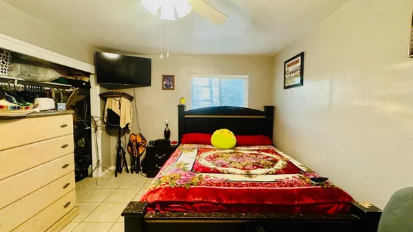 a bedroom with a bed and a flat tv screen