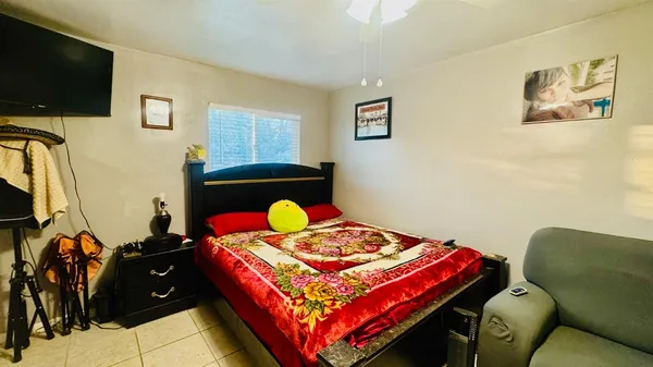 a bedroom with a bed and a flat screen tv